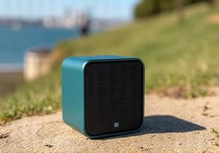 A compact, rugged wireless portable speaker set up outdoors