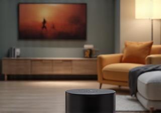 A modern smart home speaker placed in a stylish living room setting